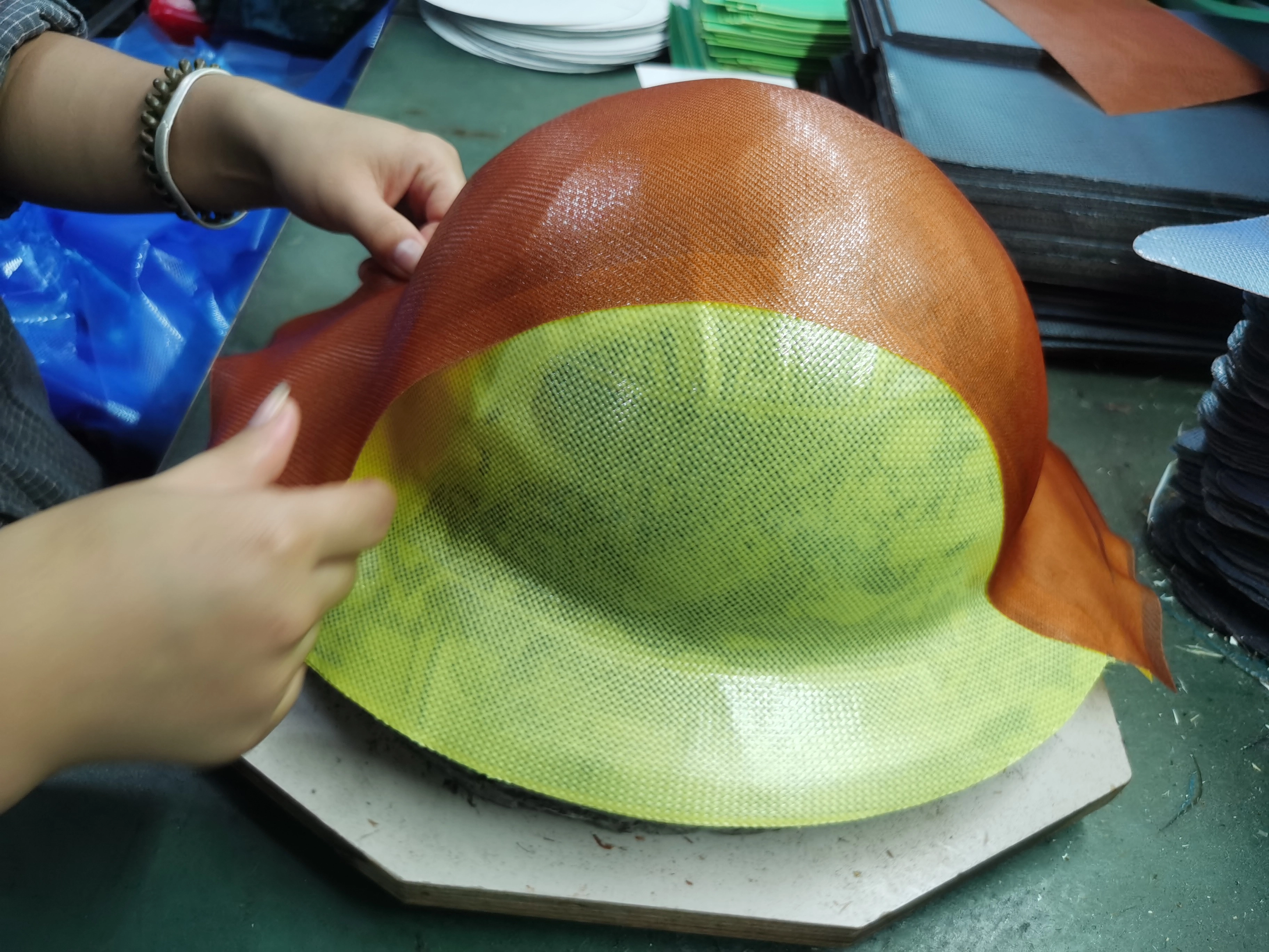 Manual composite layup on safety helmet shell mold