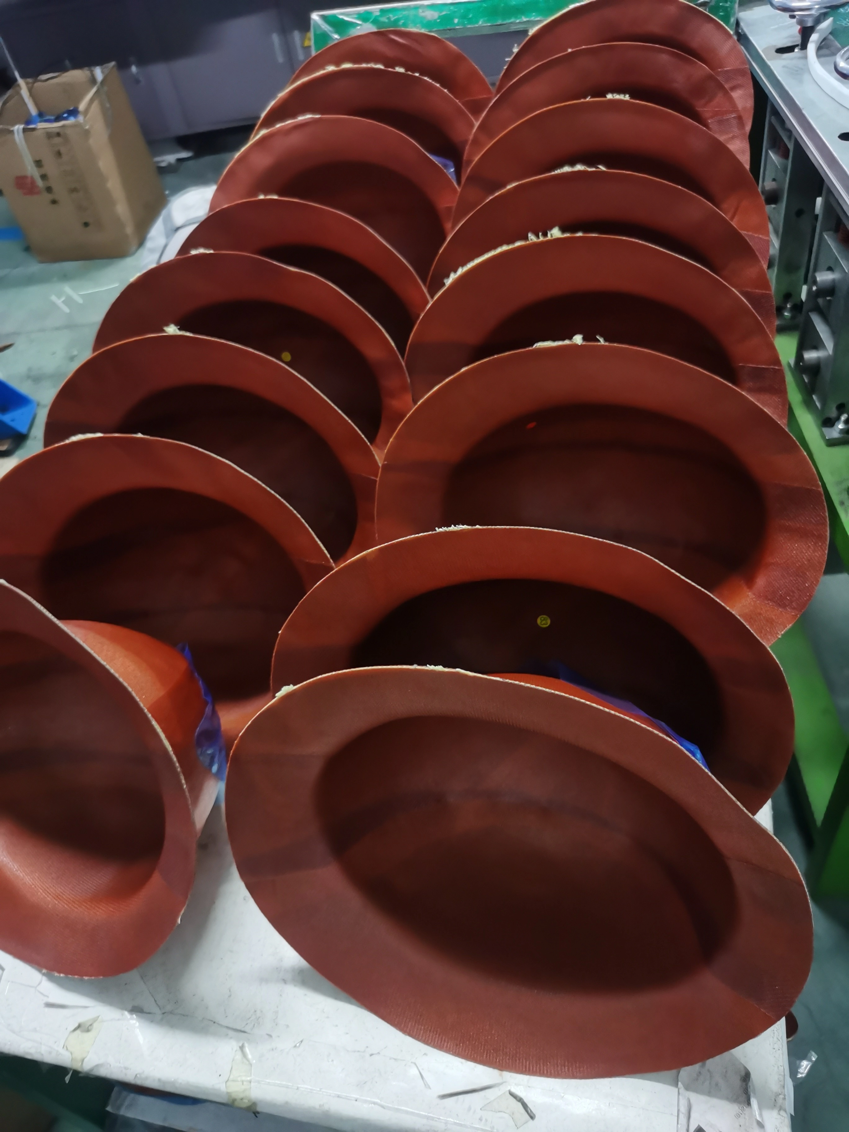 Semi-finished safety helmet shells during manufacturing